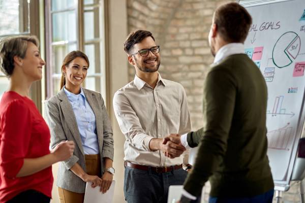 happy-coworkes-shaking-hands-after-business-presentation-office (1)